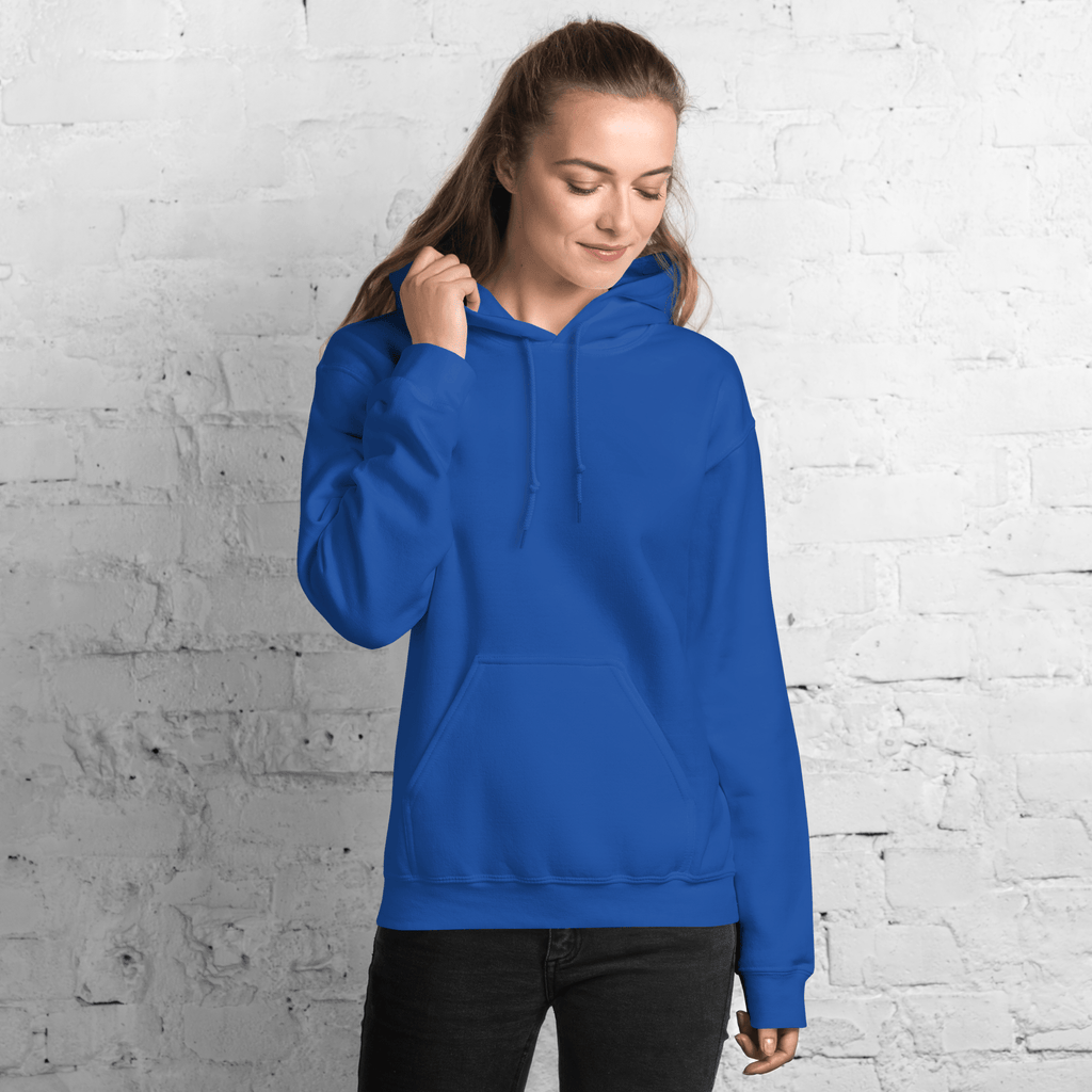 Front view of woman wearing blue hoodie, standing against white brick wall, casual outfit - SublimeElle Self - Love