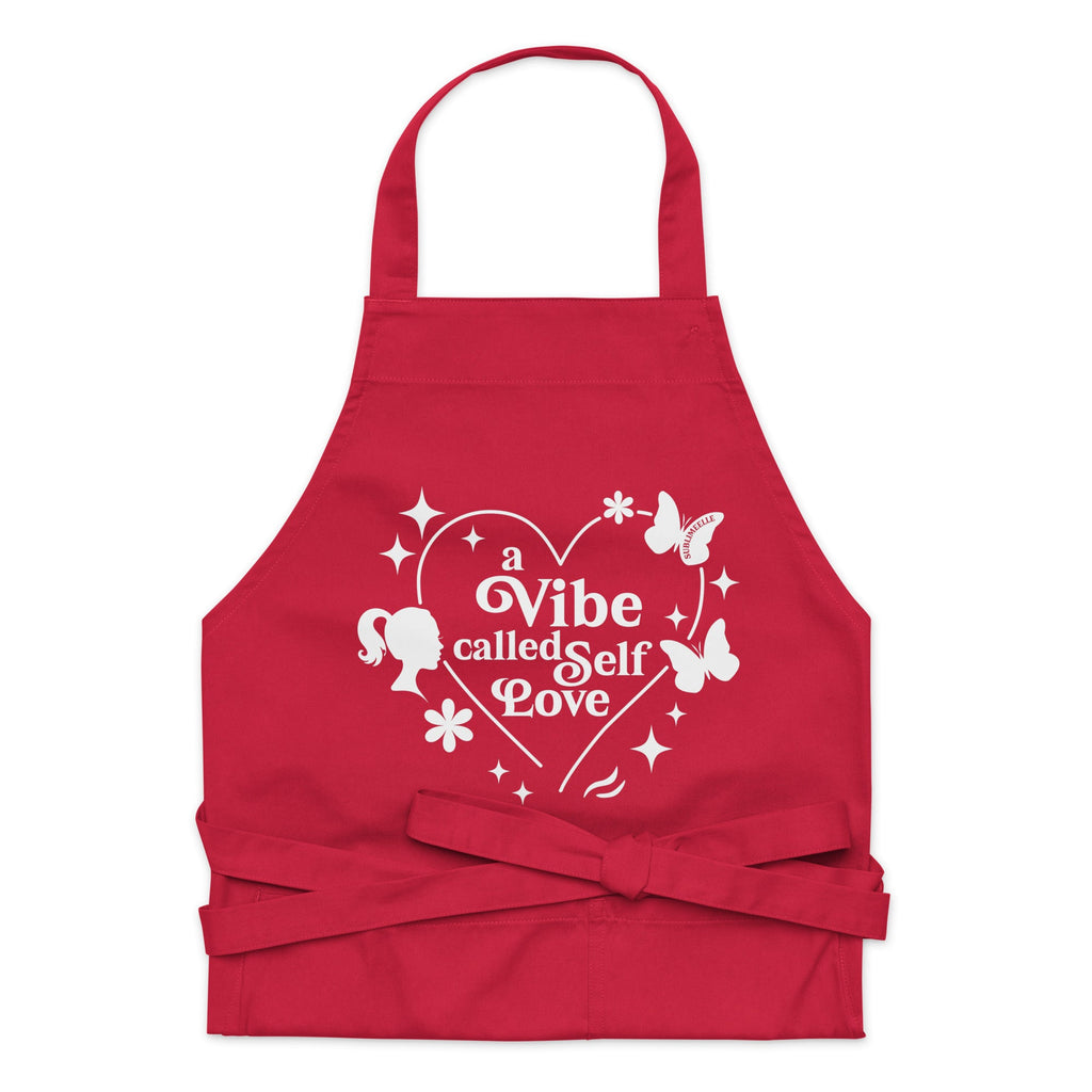 Front view of red apron with quote and design ‘A Vibe Called Self-Love,’ tied strings, stylish and inspirational kitchen wear- SublimeElle Self - Love