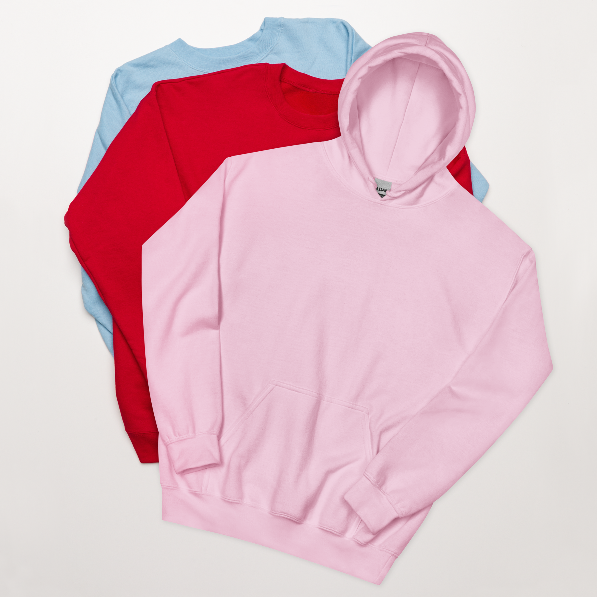 Front view blush pink hoodie among two other colored hoodies. Cozy self love and self care sweatshirt for women, promoting mindfulness, self growth, and everyday confidence. Design and quote in the back: 'a vibe called self-love'